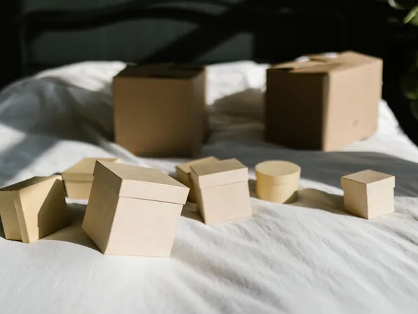 Kraft gift boxes waiting to be packed on a linen cloth
